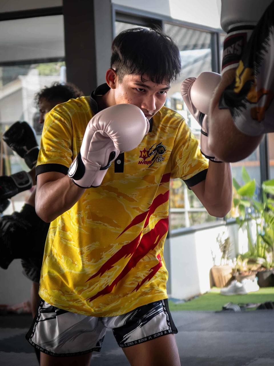 Boxing gloves training at Chatpichit Muay Thai
